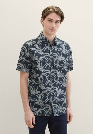 Short-sleeve navy shirt with white palm leaf pattern, button-front design, and a collar. Fabric appears lightweight with a textured finish.
