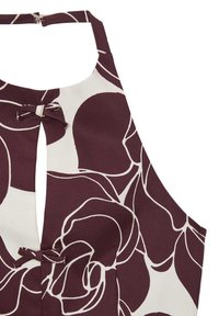 Top senza maniche con un profondo motivo floreale color maroon su uno sfondo crema. Include un'apertura a chiave e un'accoppiatura a fiocco sul collo.