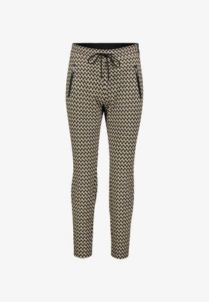 Patterned slim-fit pants with a black and cream geometric design, featuring a drawstring waistband and zippered side pockets.