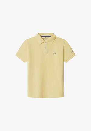 Bledožuta polo majica od pamuka, s ovratnikom, trima gumbima i malim tamnoplavim logotipom na prsima. Kratki rukavi.