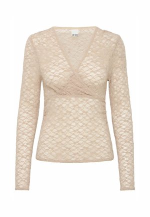 Kremkrāsas ilgu piedurknu augšdaļa, kas izgatavota no mežģīnēm ar ietīšanas dizainu un V veida kaklu. Iespējas ir viļņota apakšdaļa un sarežģīts ziedu raksts.