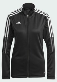 Giacca sportiva nera con colletto alto, zip completa, tre strisce bianche su ciascuna spalla e dettagli in rete sulle maniche. Presenta il logo Adidas.