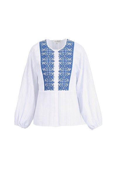 Blouse blanche à manches longues avec broderie florale géométrique bleue sur le panneau avant et poignets élastiques froncés.