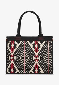 Borsa a tracolla realizzata in cotone canvas con un motivo geometrico ispirato all'tribale in nero, crema e rosso. Ha due robuste cinghie per il trasporto.