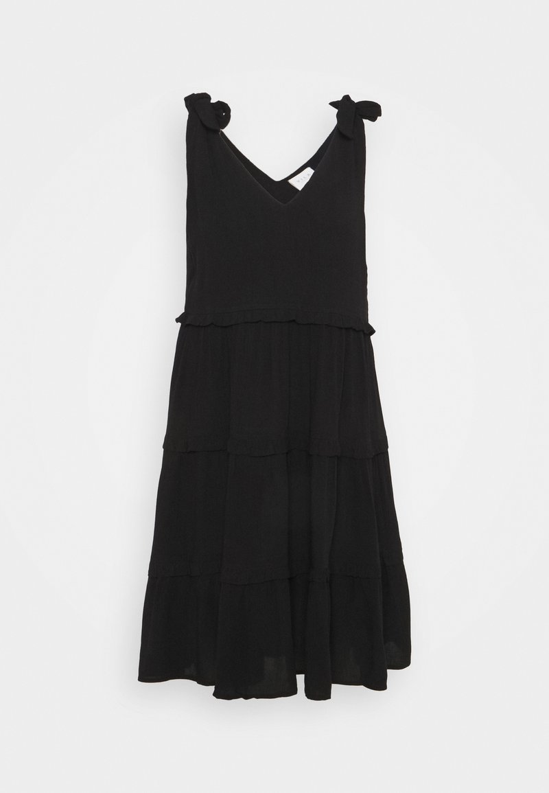 Schwarzes ärmelloses Kleid mit V-Ausschnitt, geknoteten Trägern und gestuften Rüschendetails entlang des Rocks.