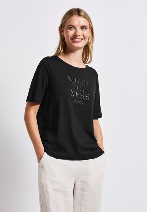 Black cotton t-shirt with short sleeves, featuring the word "MINDFULNESS" in a subtle print. Relaxed fit, with a round neckline.