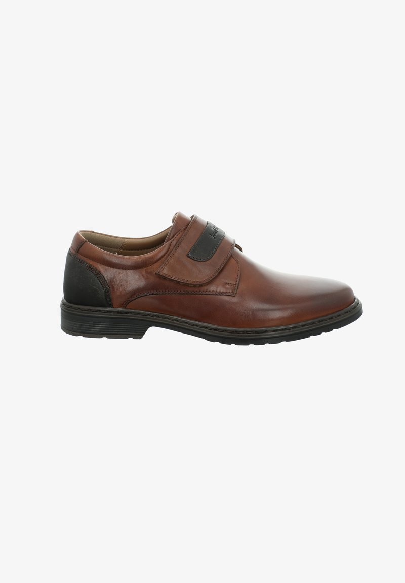 Braunes Leder-Schuh mit runder Zehenform, Klettverschluss, schwarzem Akzent an der Ferse und einer strukturierten Gummisohle. Glatte Oberfläche mit Nahtdetails.