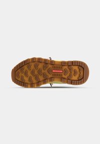 Merrell outdoor shoe with patterned tread, rubber outsole, brown base, and vibrant upper materials. Features a pink logo and sturdy laces.