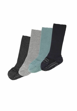 Quattro paia di calzini a coste con grip antiscivolo, nei colori grigio scuro, grigio chiaro, verde petrolio e blu navy, disposti fianco a fianco.