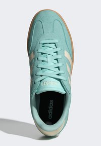 Aqua blue sneaker featuring suede and synthetic leather, with cream stripes and logo, lace-up design, and a textured rubber sole.