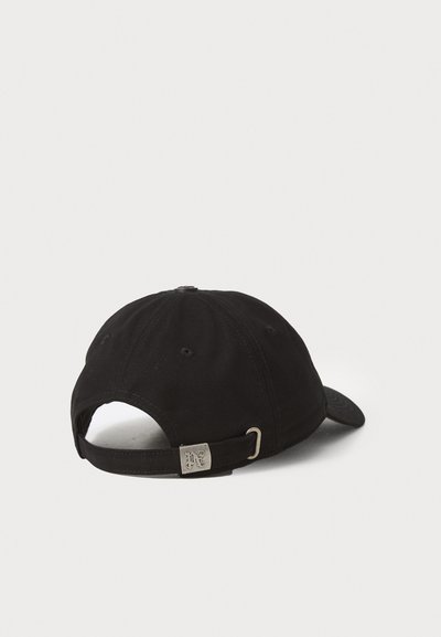 Black cotton cap with a curved brim, adjustable strap at the back, featuring a silver metal accent and visible stitching details.