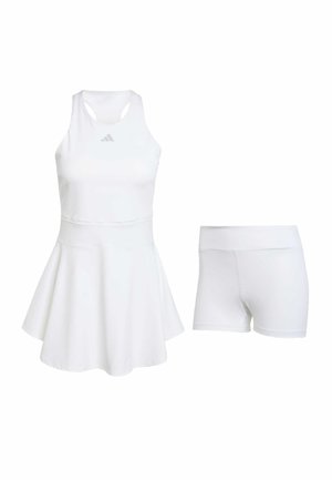 Conjunto deportivo blanco que incluye una camiseta sin mangas con falda acampanada y cintura a juego, acompañado de pantalones cortos ajustados blancos con una textura suave.