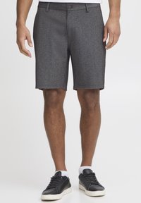 Gray textured chino shorts with a slim fit, belt loops, and front pockets, paired with black sneakers and white ankle socks.