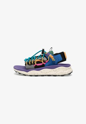 Colorful sports sandal with purple sole, black and blue straps, turquoise and yellow laces, wooden beads, and speckled white cushioned midsole.