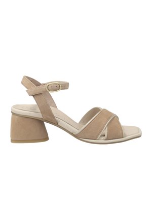 Beige suede sandal with an ankle strap, a square toe, and a chunky heel. Features crossed front straps and a gold buckle detail.