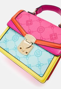 Colorful handbag featuring a pink textured upper, blue base with a pattern, yellow trim, and a gold clasp with circular accents.