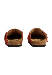 Red suede slip-on sandals with an open back, cork footbed, and black rubber sole. Features adjustable straps for a secure fit.