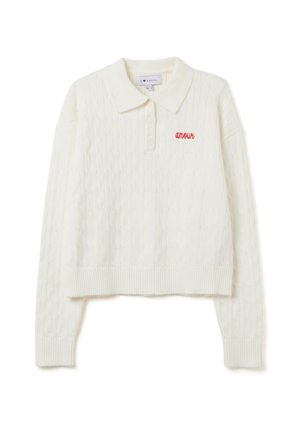 Suéter de polo blanco de crochet con dobladillo y puños acanalados, que cuenta con un pequeño bordado rojo de "amour" en el lado izquierdo.
