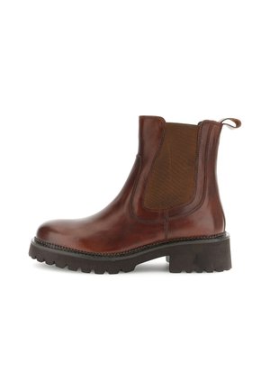 Bruine leren Chelsea-boot met een dikke zwarte zool, elastische zijpaneel en trekbandje aan de achterkant.