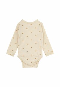 Långärmad babys body i mjuk beige tyg med små gyllene hjärtan. Har rund halsringning och scallopade kanter på ärmarna.