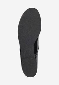 Black shoe sole with a textured, rubber-like surface. The shape is elongated and slightly curved at the toe. No visible logos or patterns.