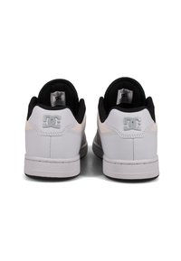 White leather sneakers with black accents, low-top design, cushioned collar, and grey logo on the heel. Smooth texture with durable rubber sole.