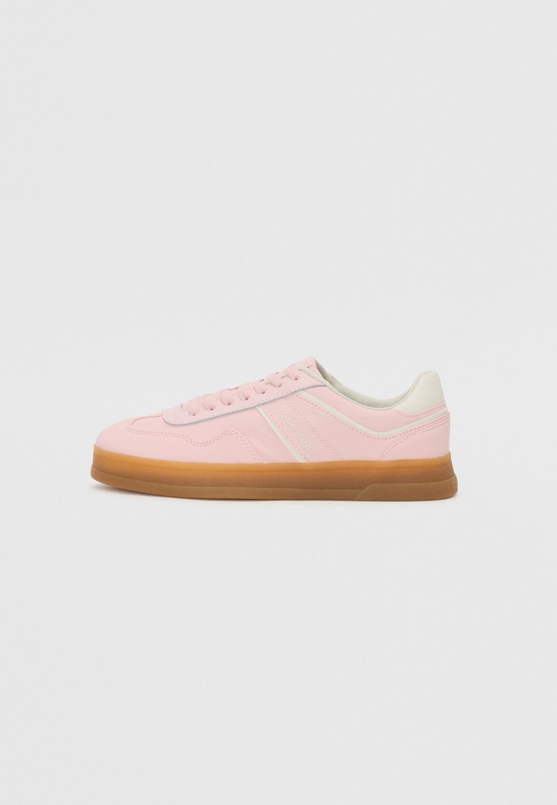 Rosa sneakers i mocka och syntetiska material, vita accentfärger, rund tå och gummisula; snörning och varumärkesdetalj på sidan.