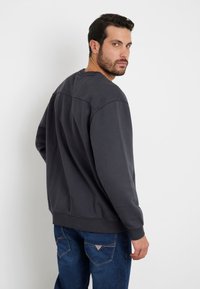 Guess LOGO - Sudadera - schwarz