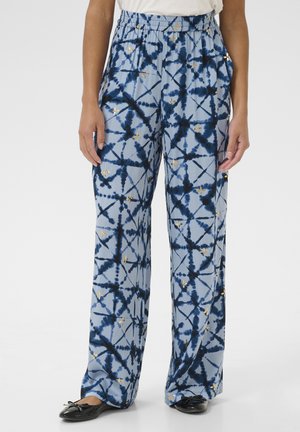 Pantalons relax fit bleu clair avec un motif tie-dye en marine et des accents dorés. Ceinture élastique pour plus de confort, silhouette à jambes larges.