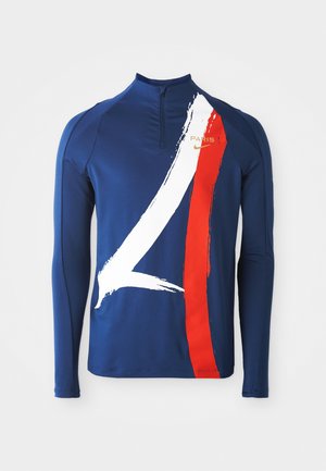 Mornarsko moder dolg rokav s četrt zadrgo. Ima bele črte z barvanjem in rdečim poudarkom. Zlata oznaka "PARIS" in Nike logotip na levem prsnem delu. Gladka tekstura.