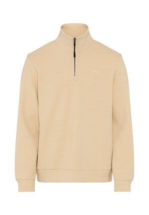 Pullover beige a mezza zip con collo alto, maniche lunghe, polsini e orlo a costine, e un piccolo logo del marchio sul petto.