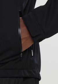 ION Chaqueta softshell - black