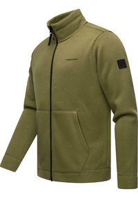 Giacca a zip verde oliva realizzata in tessuto a coste, con colletto alto, tasche anteriori, zip nera e patch con logo sulla manica.