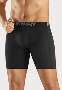 Black boxer briefs made of soft, elastic material. Features a logoed waistband and a snug fit, providing comfort and support.