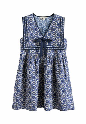 Ärmelloses blau-weißes Kleid mit Blumenmuster, rechteckigem Ausschnitt, marineblauer Einfassung und einer marineblauen Schleife vorne am gerafften Rock.