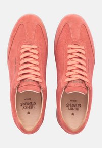 Coral suede sneakers with a rounded toe, lace-up design, and subtle branding inside. Soft texture and lightweight rubber sole.