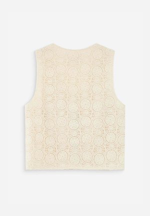 Ærmeløs cremefarvet hæklebluse med cirkulært mønster, brede skulderstropper og lige kant, vist på en hvid baggrund.