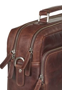 Sac en cuir brun avec une finition texturée, double zipper, quincaillerie en argent et une poignée rembourrée pour le transport. Possède des accents de sangle attachés.