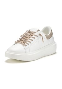 White sneaker with a smooth leather upper, rounded toe, metallic gold laces, and a grey suede heel accent on a thick white sole.