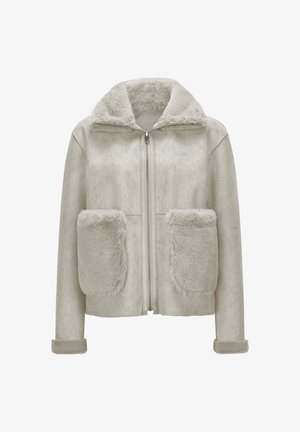 Cream-colored faux fur jacket with a front zipper, large furry front pockets, a wide collar, and turned-up cuffs.