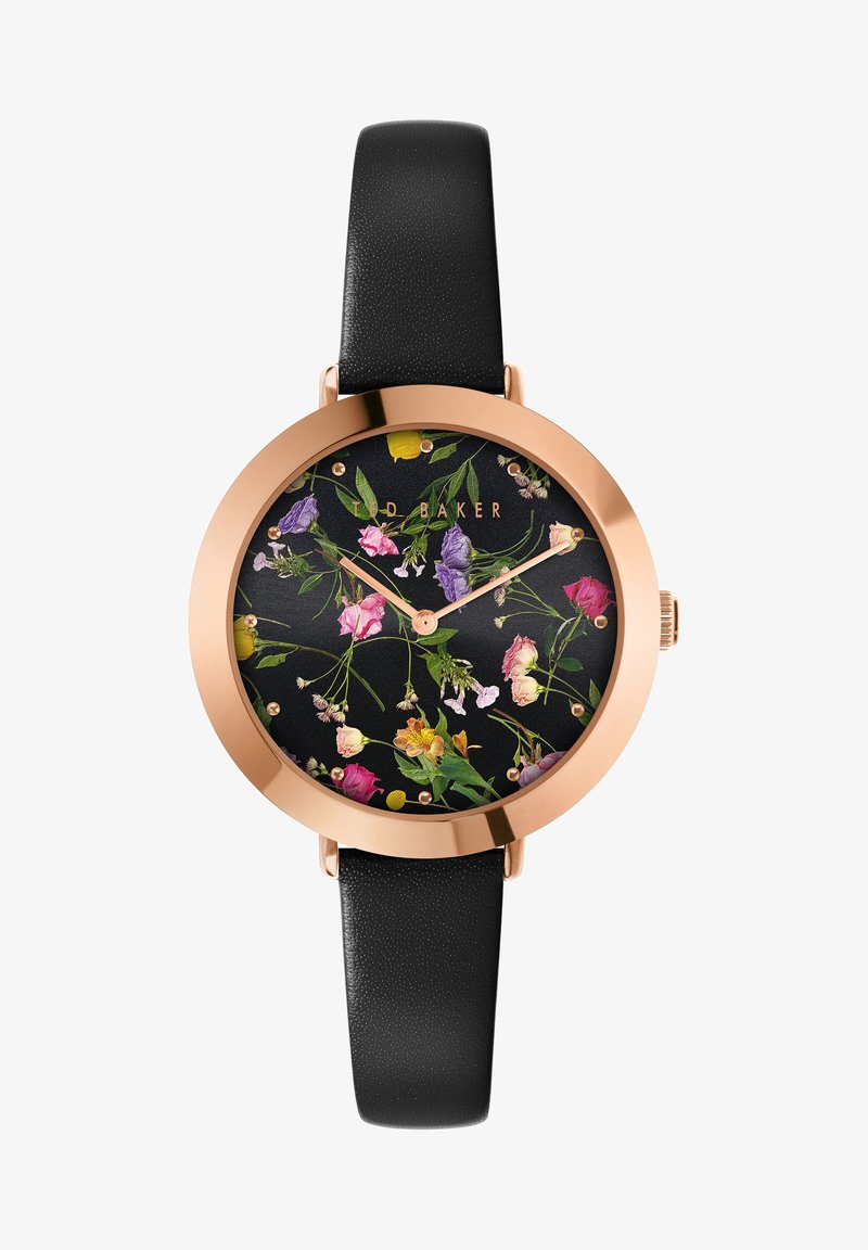 Ümmargune kell, mille musta lillemustriga sihverplaat, kuldse tooniga käed ja roosa kuldne raami. Must tekstureeritud nahkrihm.