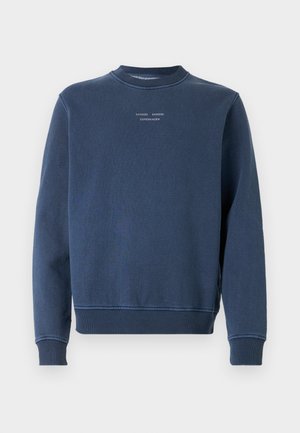 Marineblå sweatshirt lavet af tekstureret bomuld. Har en rund hals, lange ærmer og ribbede manchetter. Branding vises på brystet.