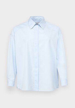 Light blue button-up shirt made of smooth fabric, featuring a classic collar, long sleeves, and a straight cut with no visible patterns.