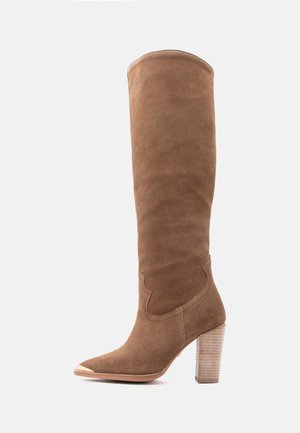 Tall brown suede women's boot with stacked wooden block heel and metallic toe cap on white background.