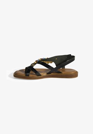 Black leather sandal with a textured footbed, beaded embellishments and a cross-strap design. Flat sole with a brown base and gold accents.