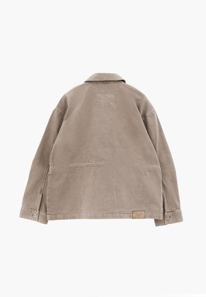 Beige long-sleeve jacket with collar, buttoned cuffs, visible stitching, and a small rectangular label near the bottom hem on the back.