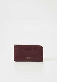 Burgundy leather wallet with a zip closure, featuring a smooth texture and gold "COACH" branding on the front. Simple, rectangular design.