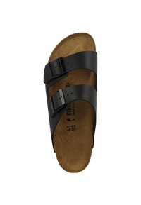 Sandale en cuir noir à deux boucles réglables, semelle en liège et texture lisse. Taille indiquée est 41, fabriquée en Allemagne.