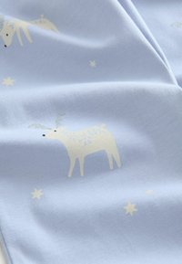 Light blue fabric featuring a pattern of white reindeer with silver accents and scattered gold stars, smooth texture.