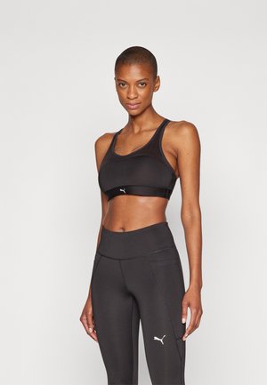 Black sports bra with a scoop neck and racerback design, made of stretchy fabric. Features a small white logo on the front.